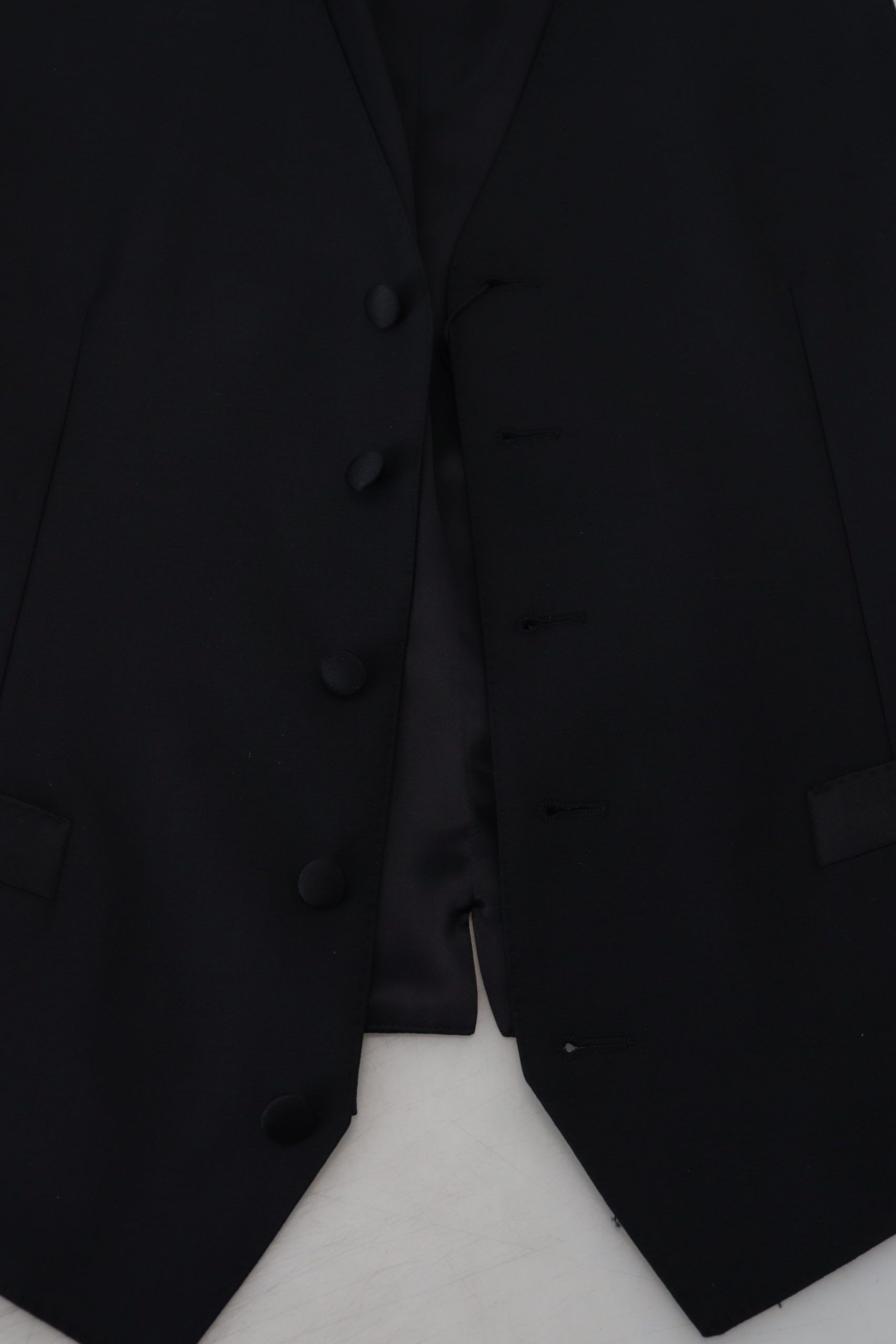 A black virgin wool waistcoat with buttons and a tie