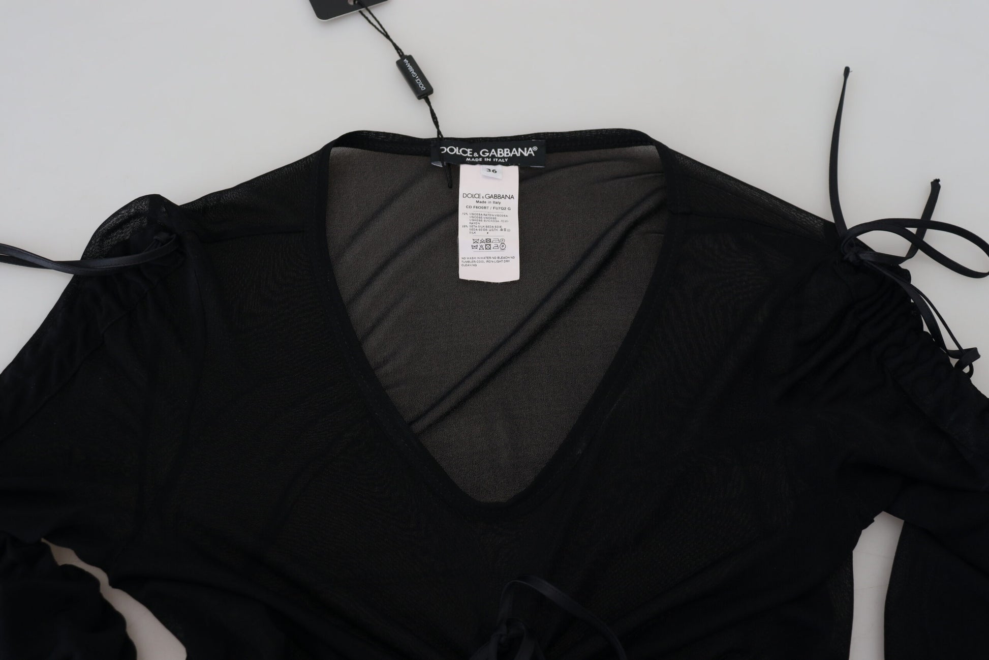 A black viscose midi dress with a sheer neckline and long sleeves