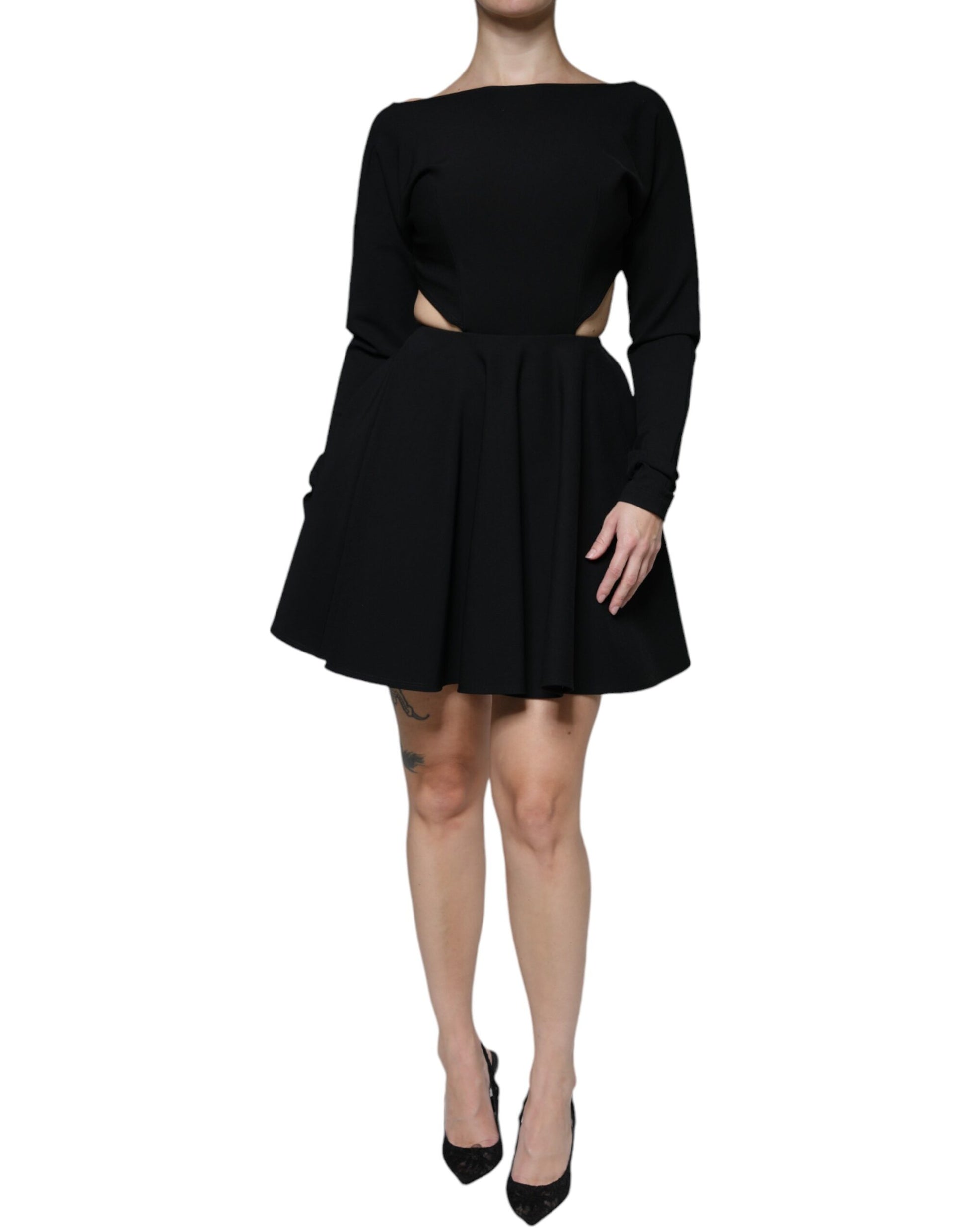 A black viscose cut out dress with long sleeves and an A-line skirt. It features a high neckline and is desig