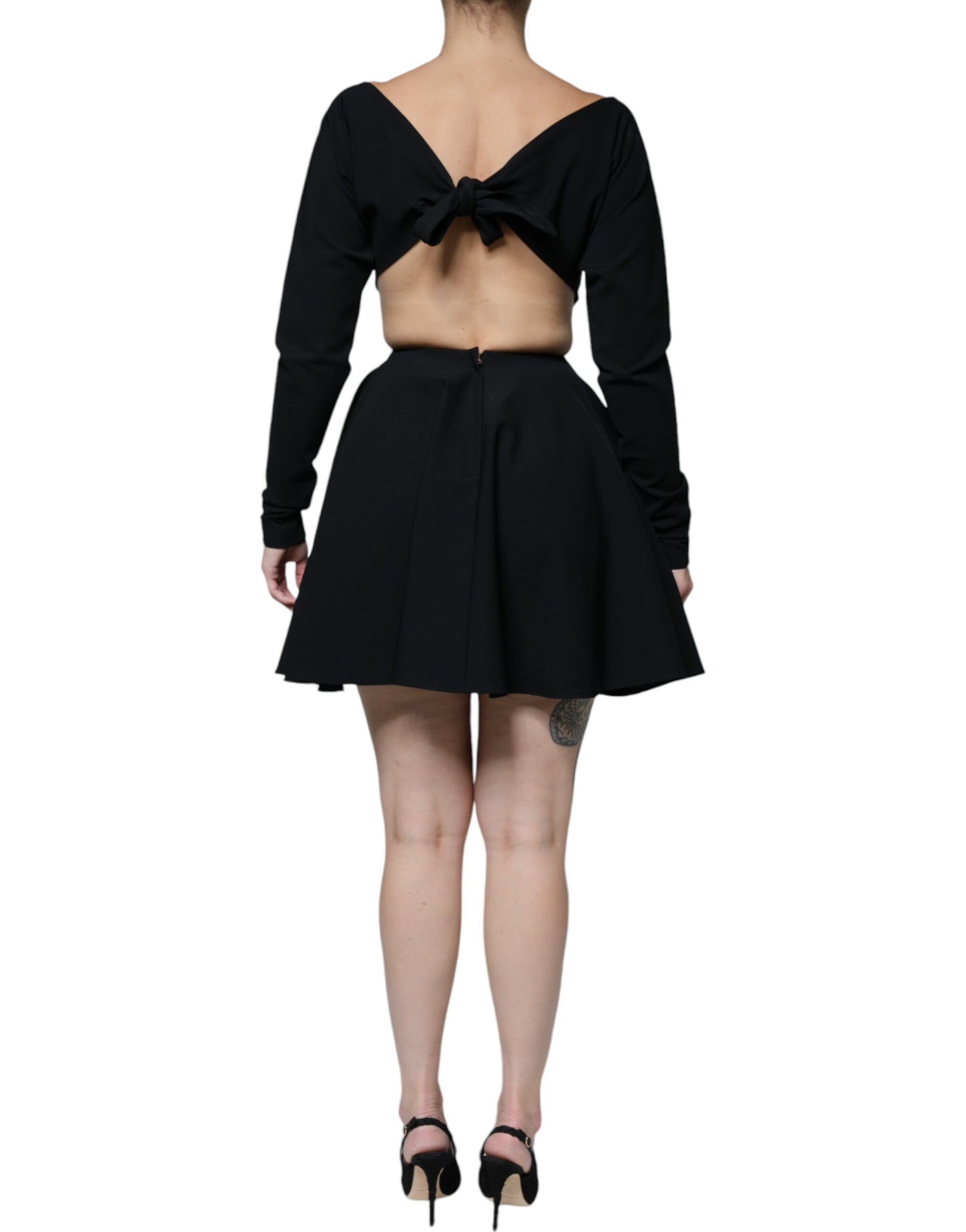 A black viscose cut out dress with long sleeves and an A-line skirt