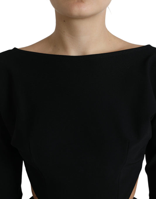 A black viscose cut out dress with long sleeves. It is an A-line style, featuring a scoop neck and a high wai