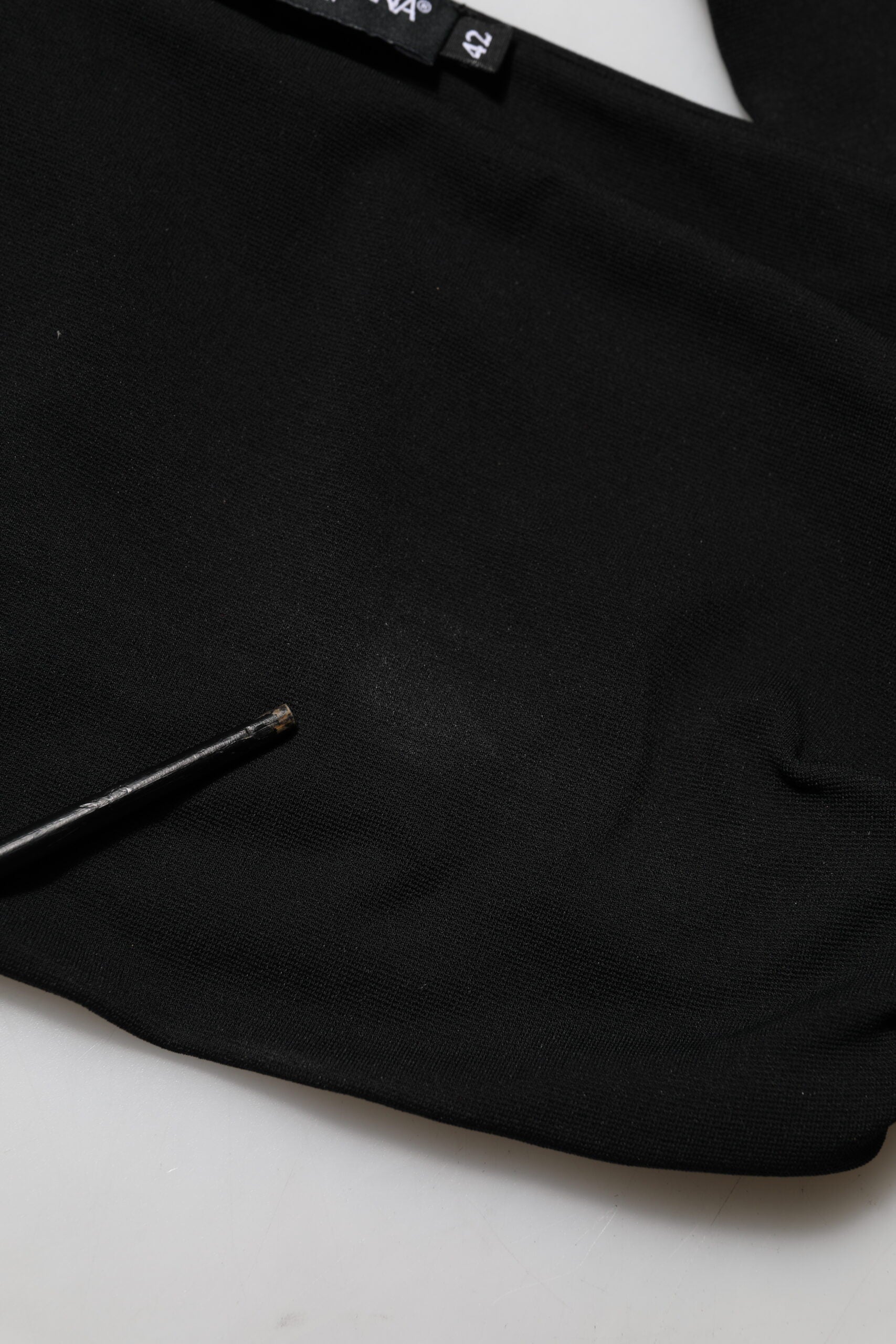 Black knitted sweater on hanger