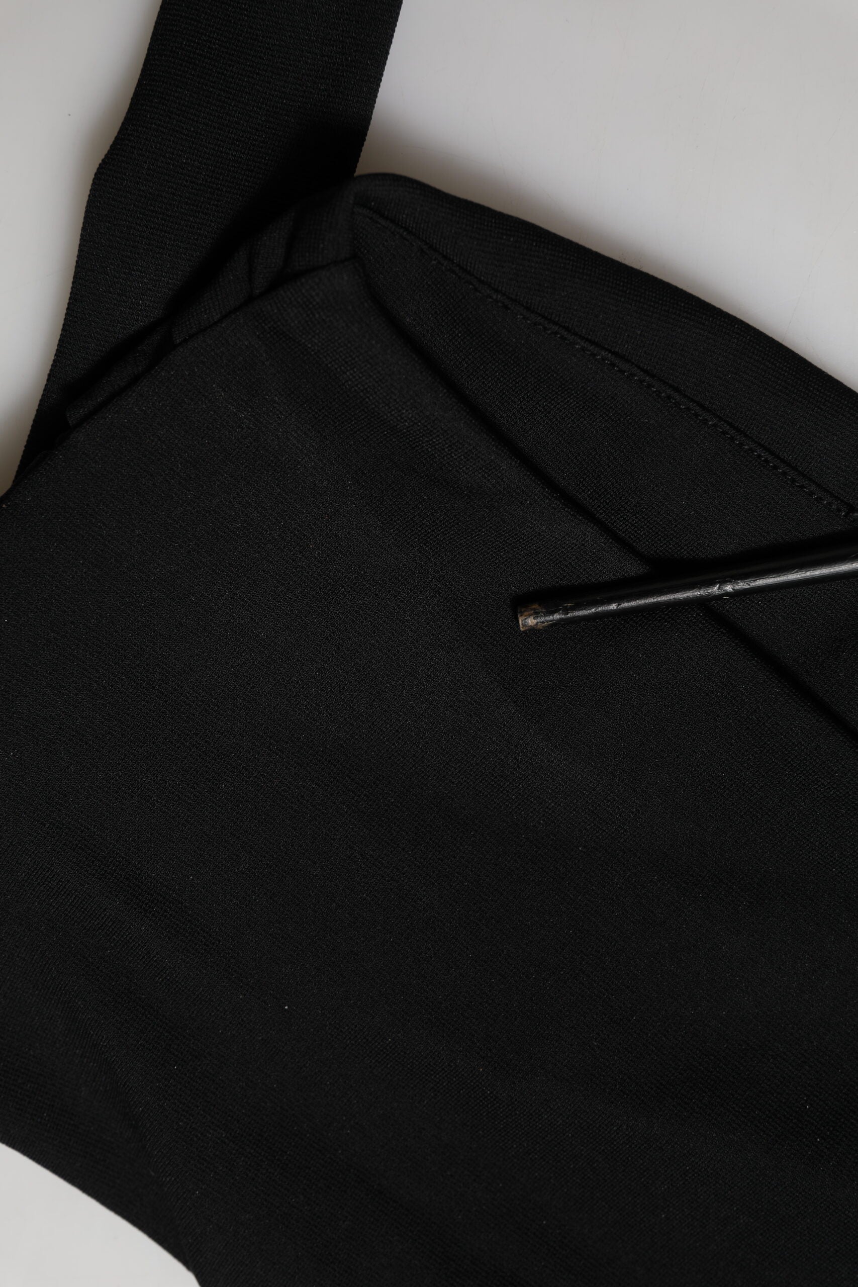 Black fabric item with a zippered pocket on front