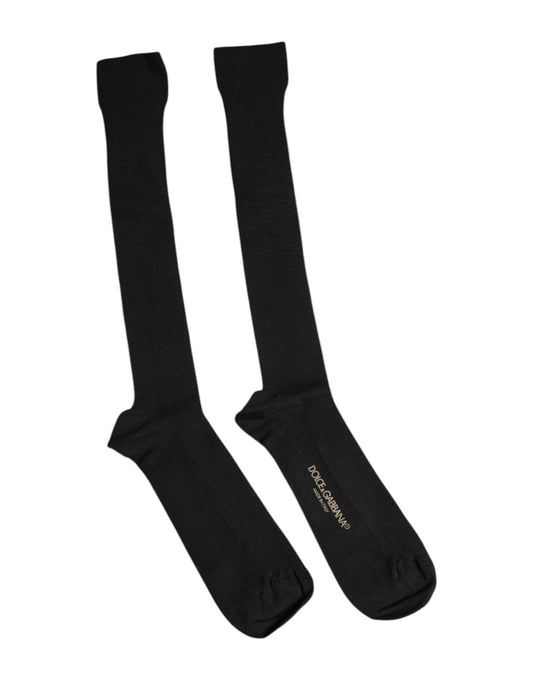 Two black socks with white stripes on top
