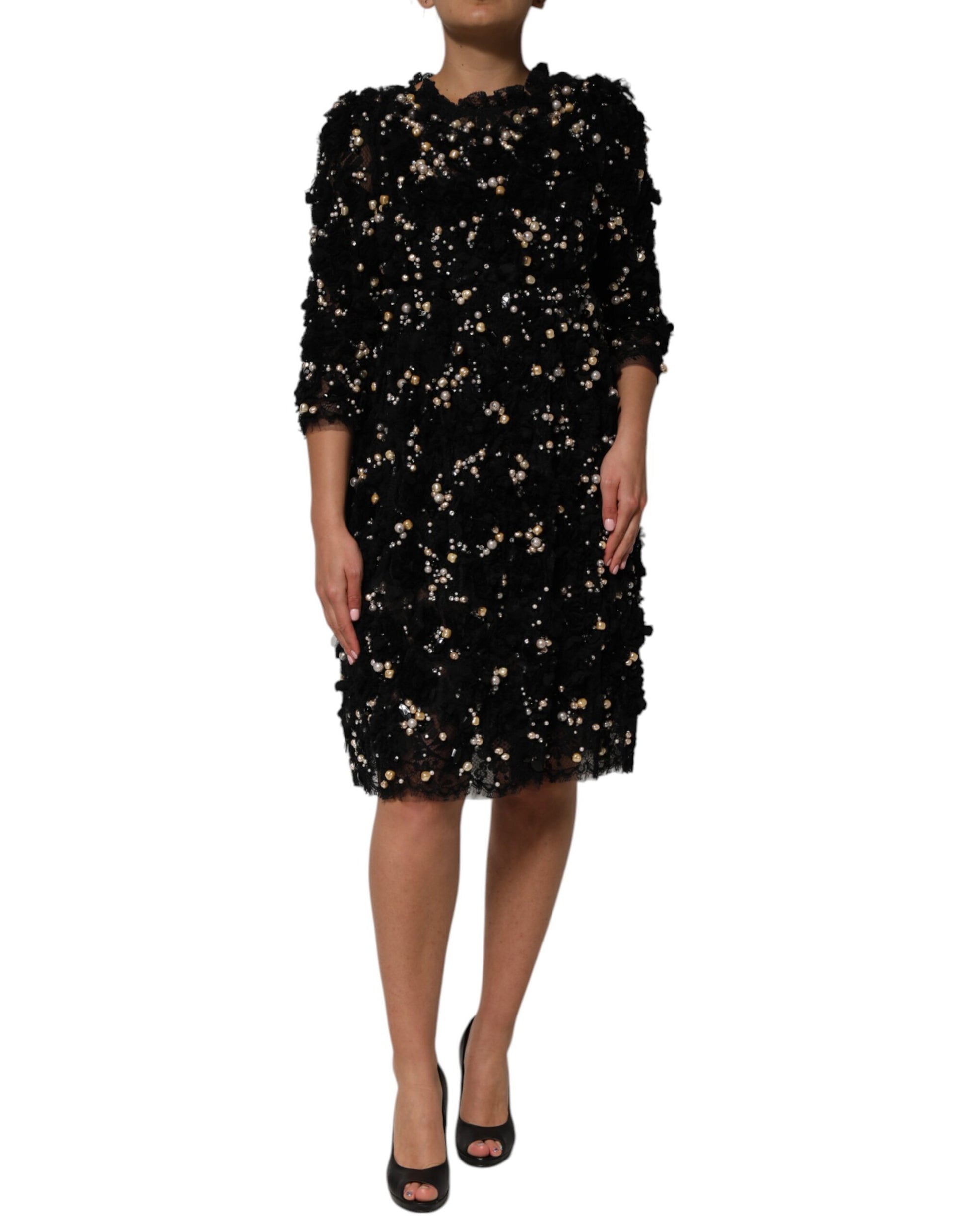 A black dress with pearl embellishments and a viscose fabric