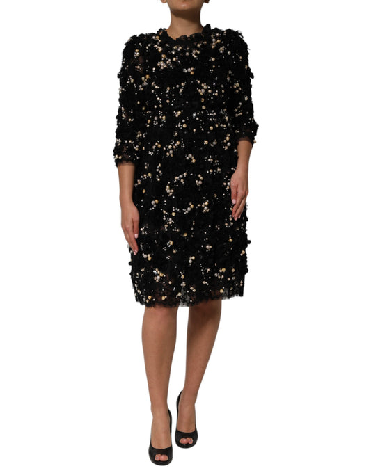 A black dress with pearl embellishments and a viscose fabric