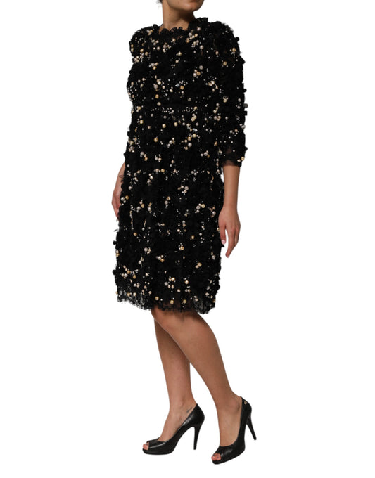 A black dress with pearl embellishments and a viscose fabric