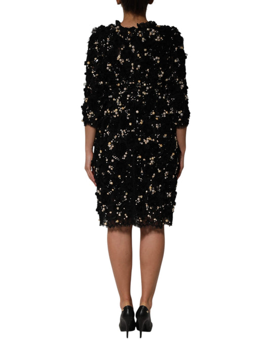 A black dress with pearl embellishments and a viscose material