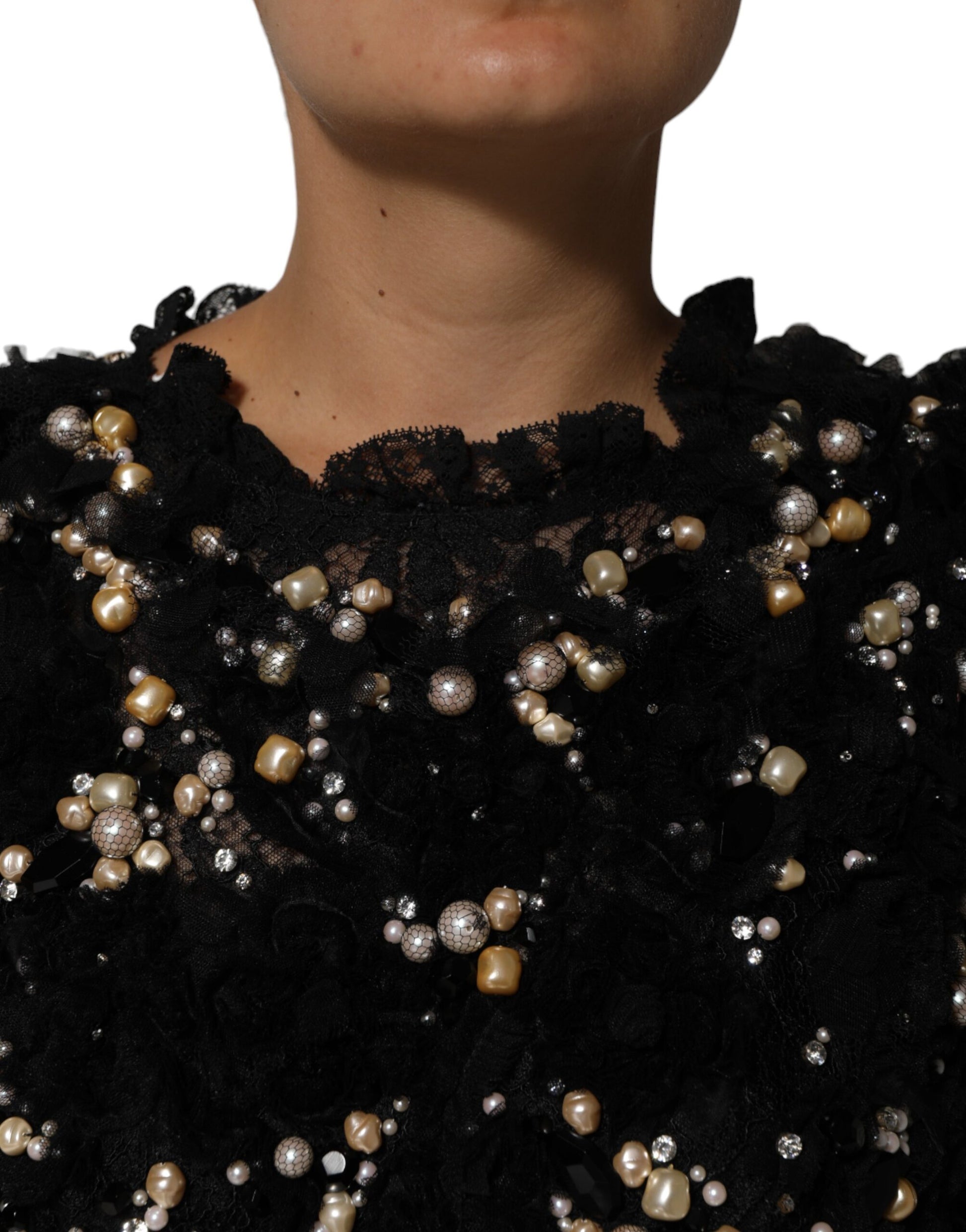 A black dress with pearl embellishments and a viscose fabric