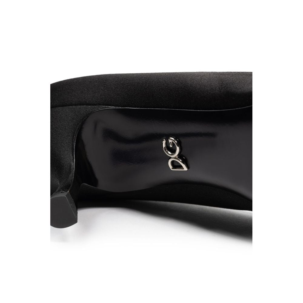 Black leather shoe with silver logo on side