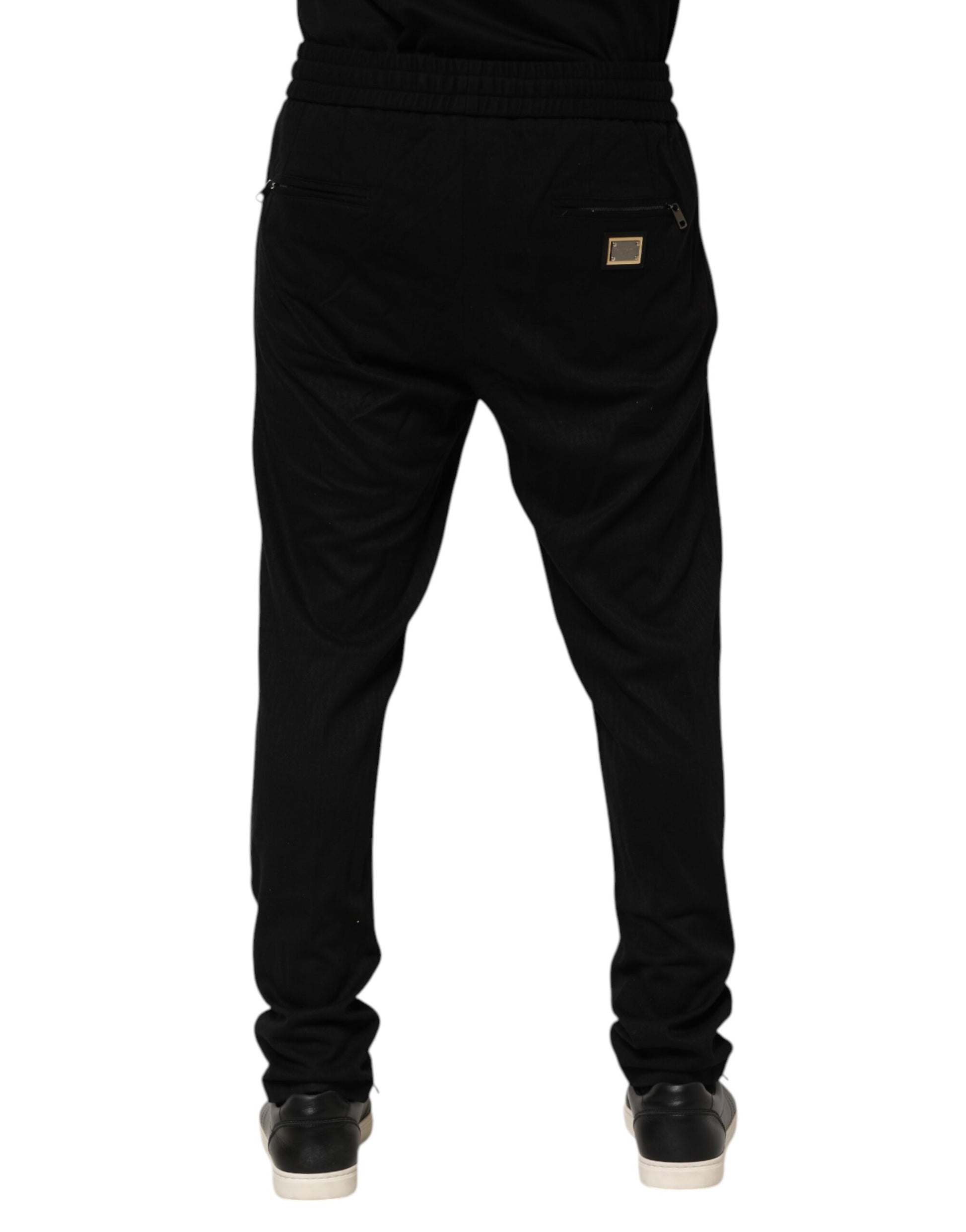 Pair of black pants with a zippered front pocket