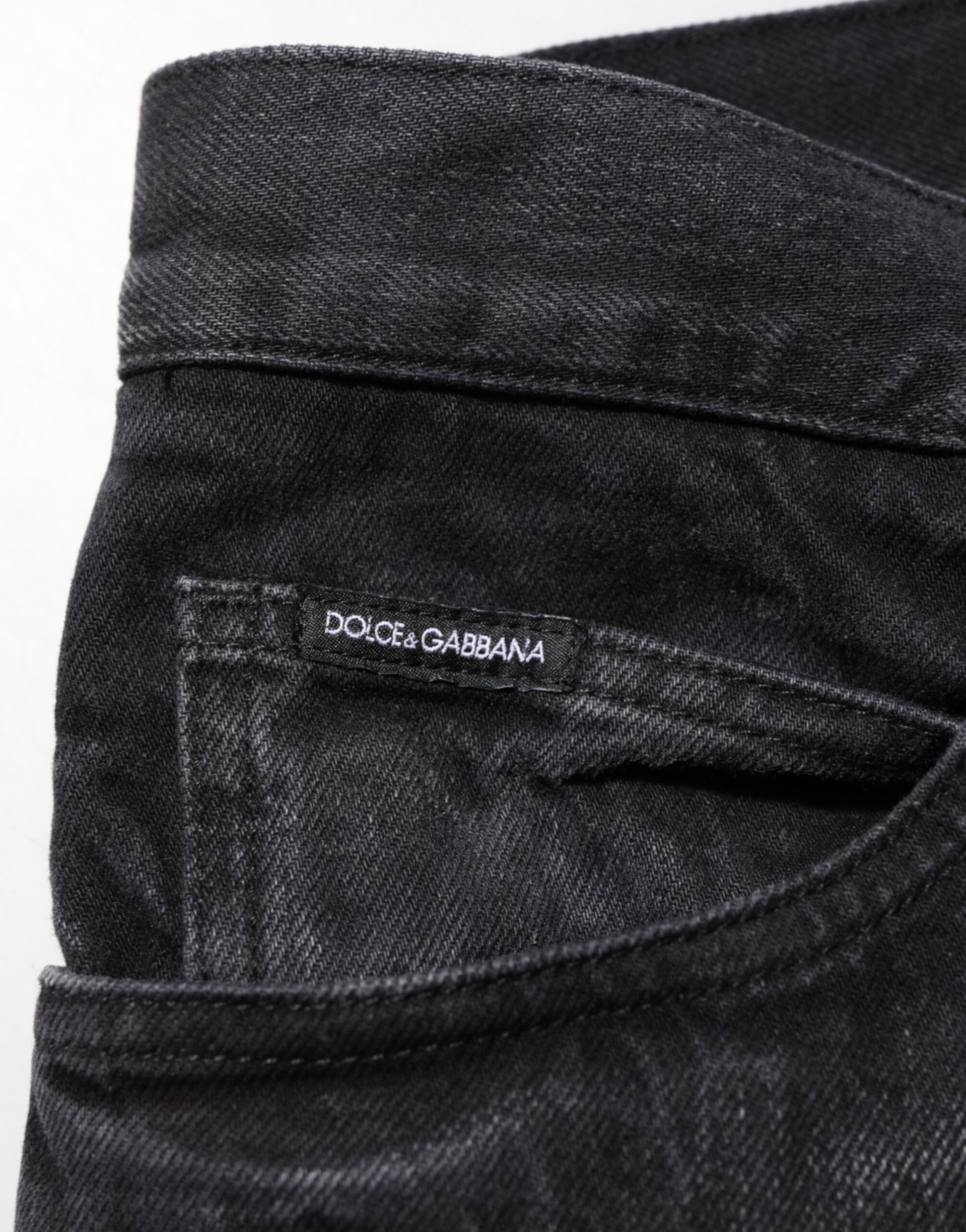 Dark blue denim jeans with brand label on waistband