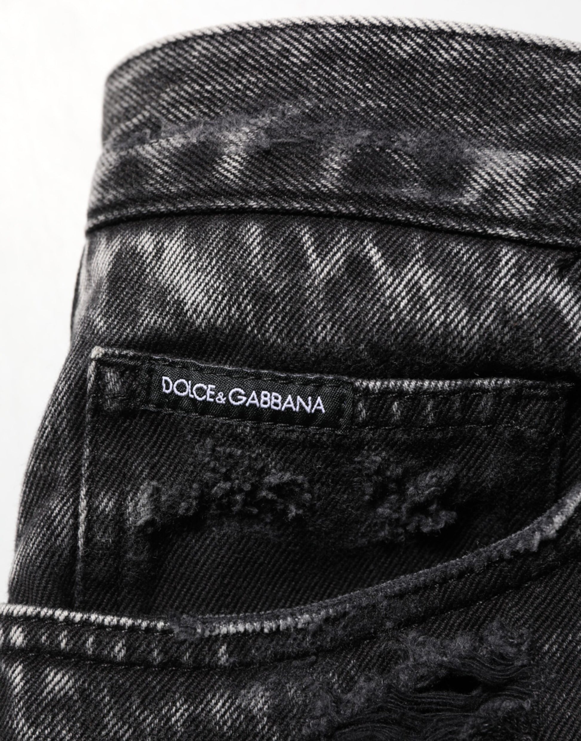 Black denim jeans with white label inside waistband