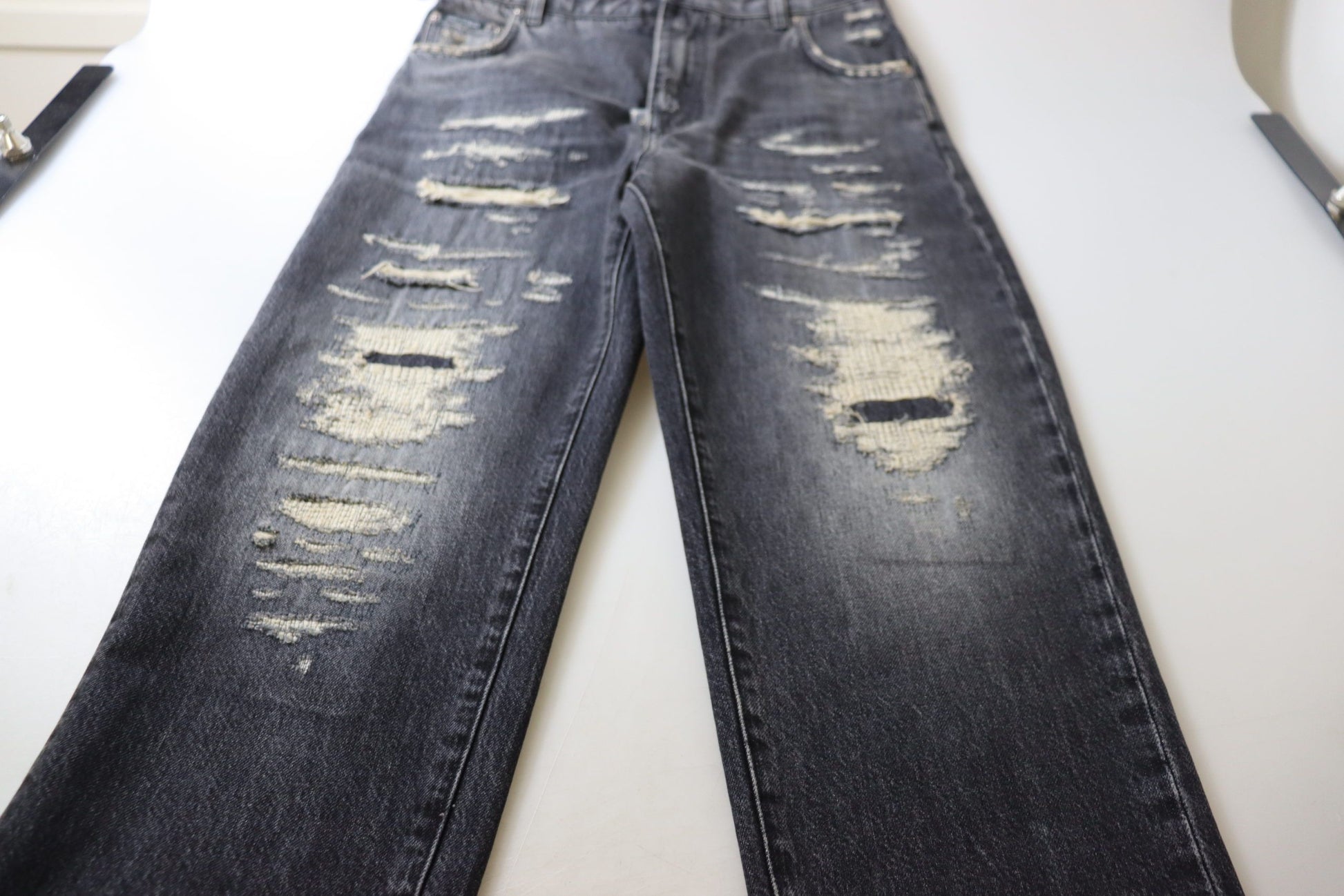 Pair of distressed jeans on display