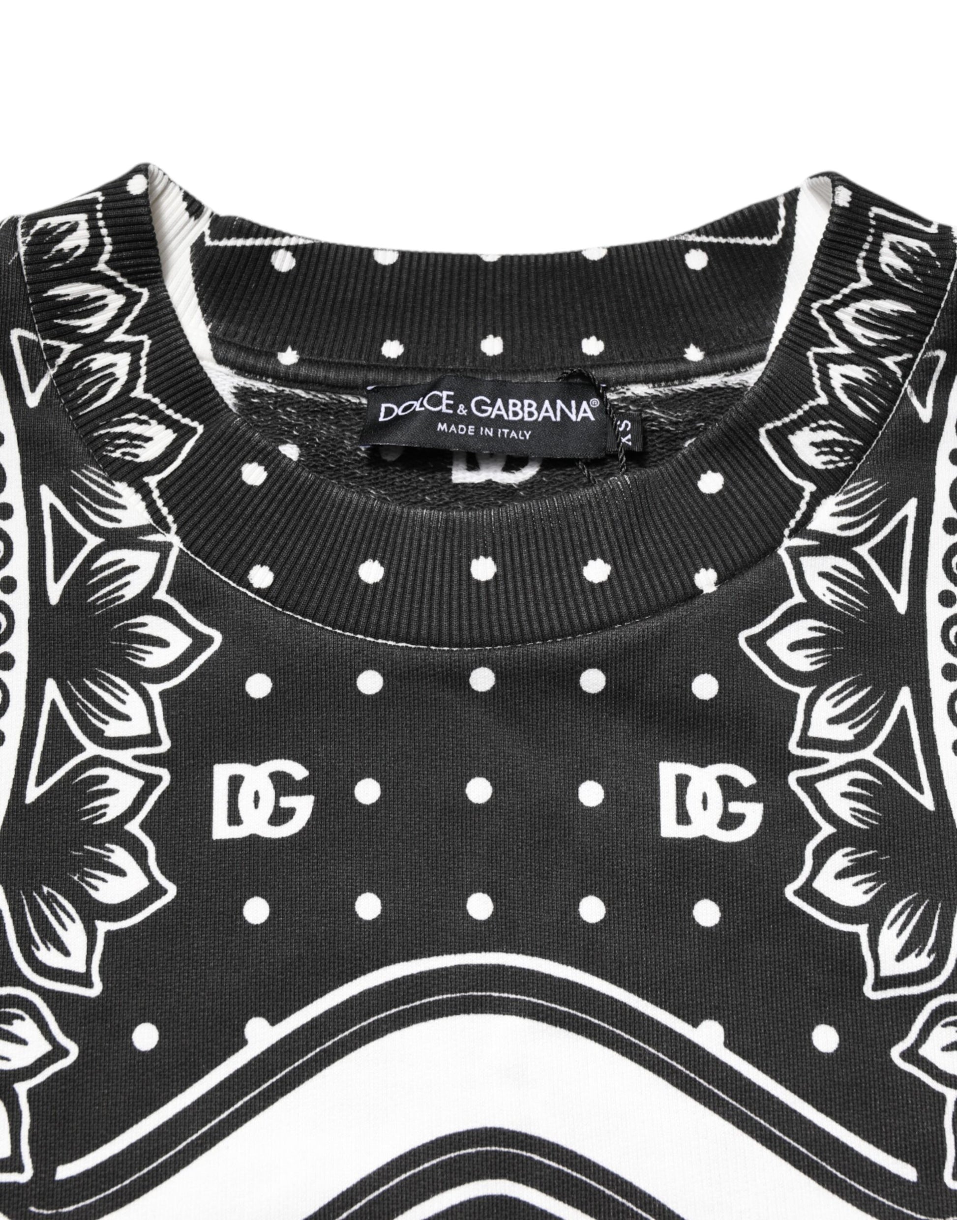 Black sweater with white polka dots and a floral pattern on the front