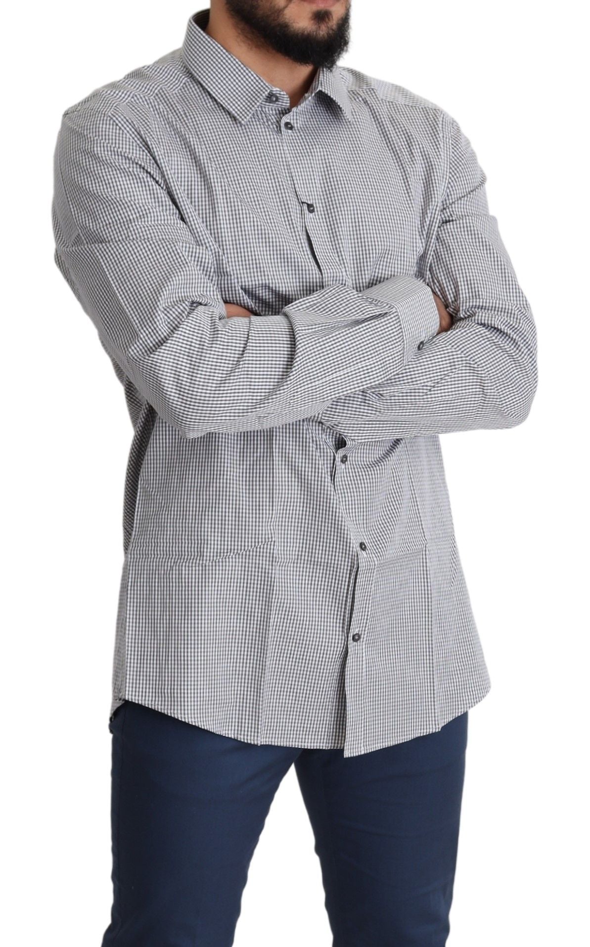 Man wearing plaid shirt and jeans standing with arms crossed