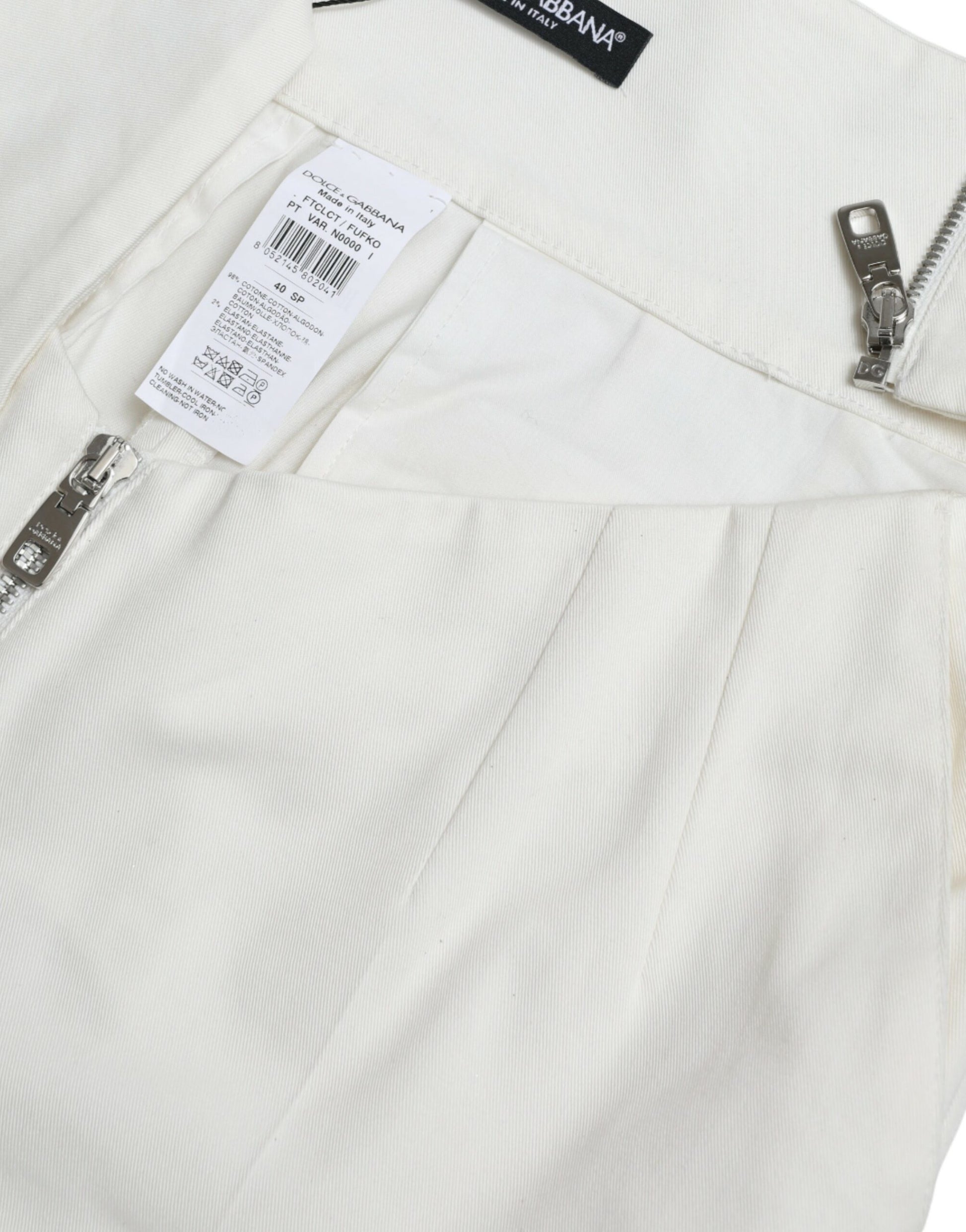White pants on a hanger with a tag