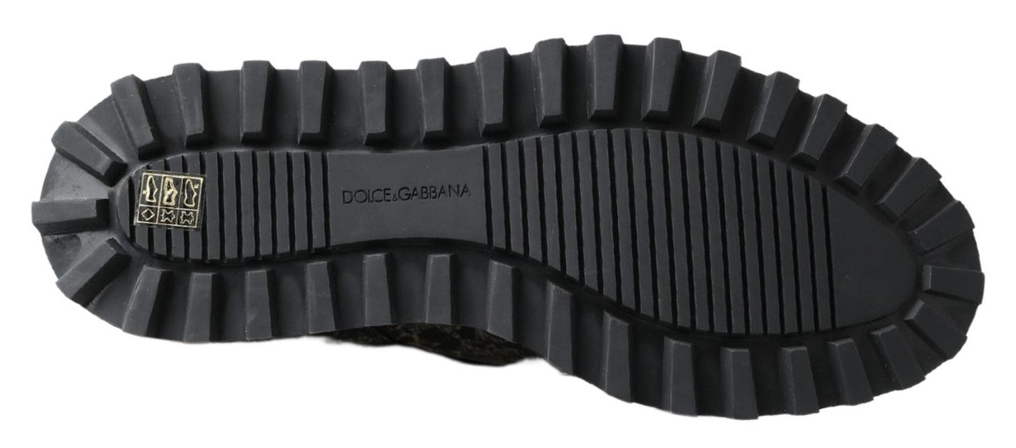 Black rubber hiking boot with deep treads and a logo on the side