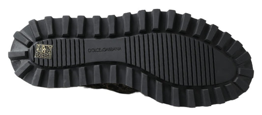 Black rubber hiking boot with deep treads and a logo on the side
