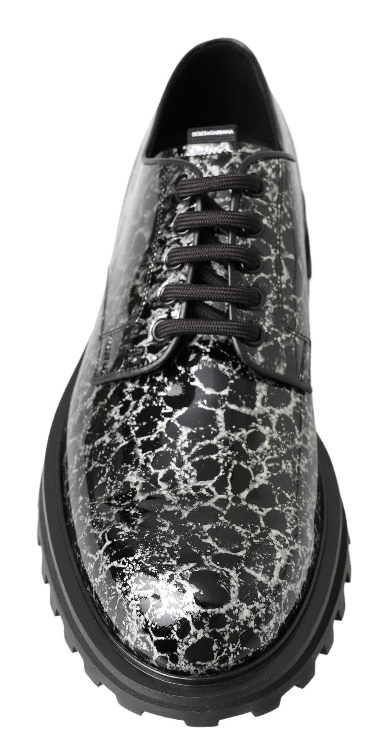 Black shoe with a patterned design on the upper and sole
