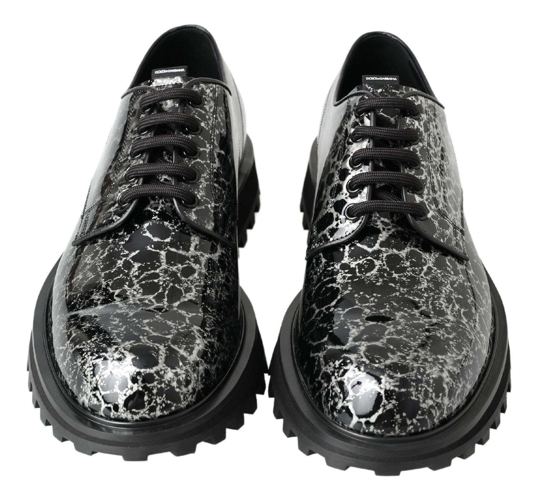 Pair of black shoes with a patterned design on the upper part