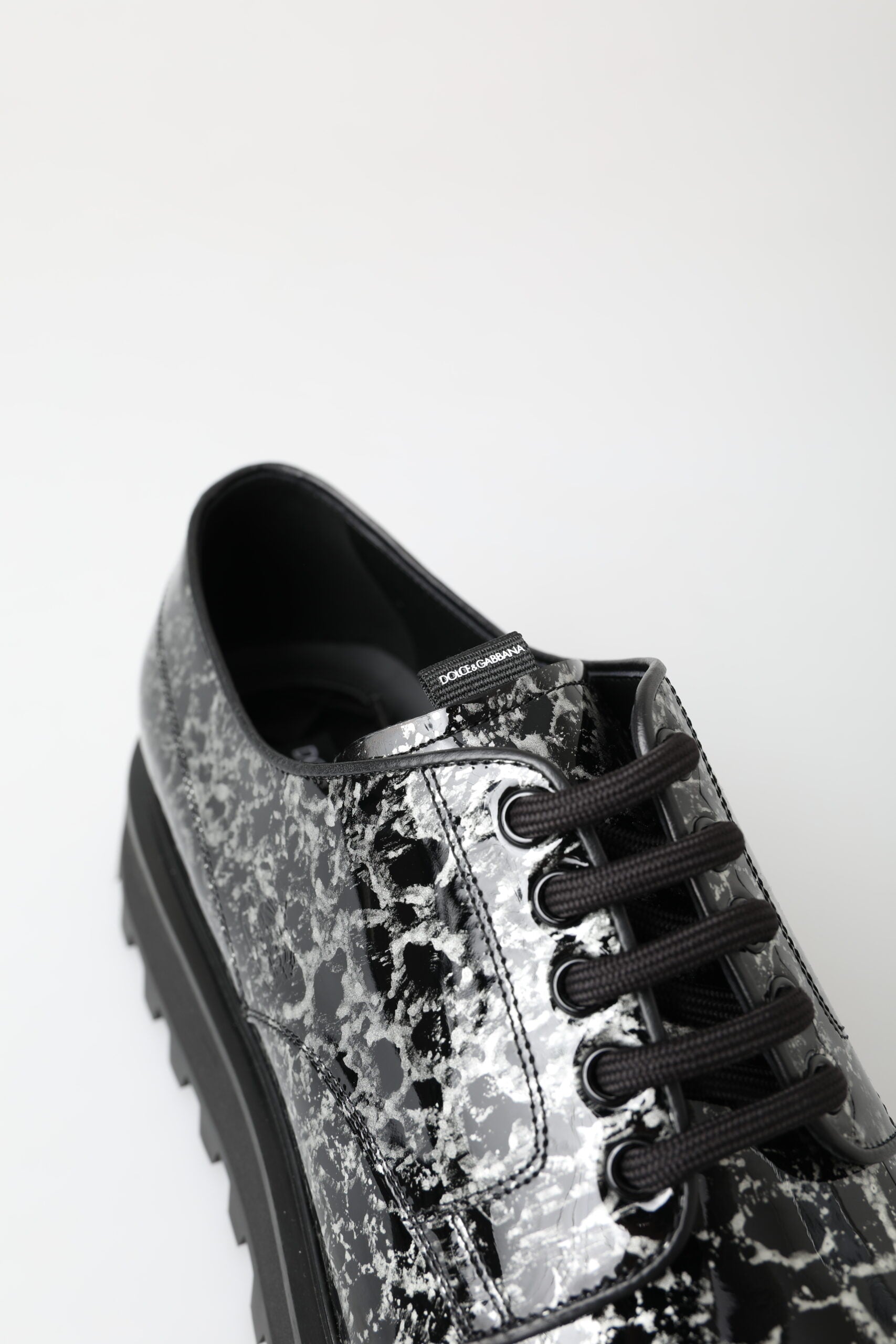 Black shoe with patterned design on toe and heel