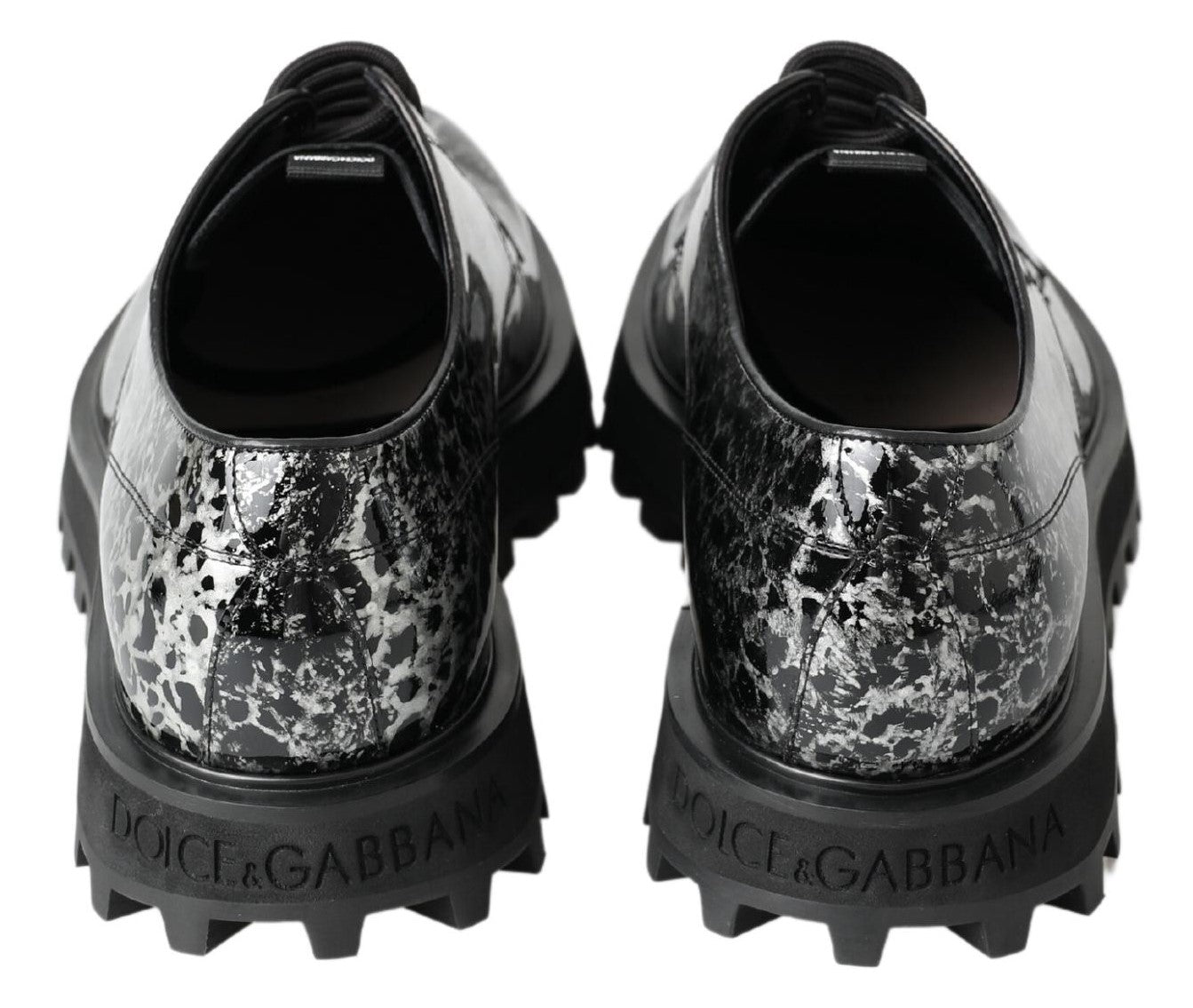 Pair of black and white shoes with a camouflage pattern on the side