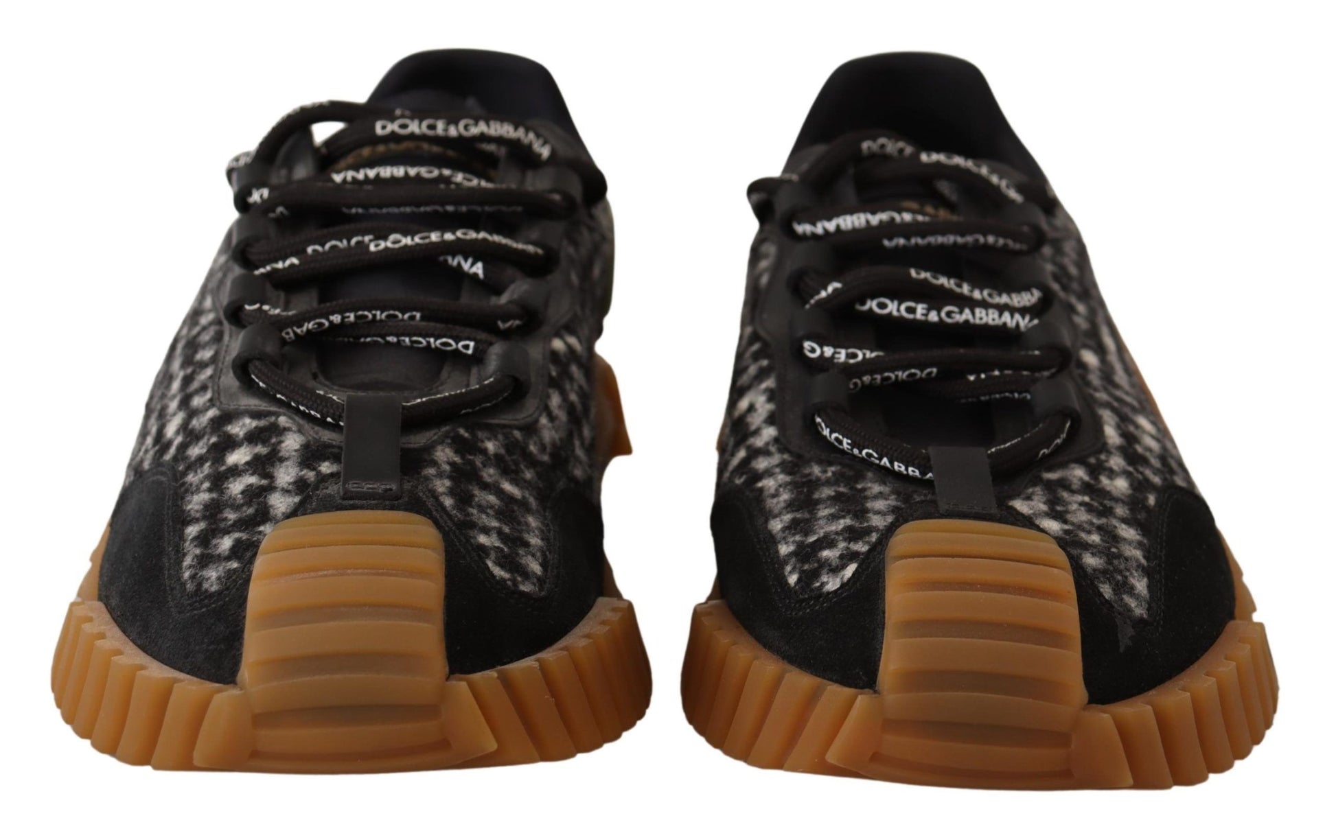 Pair of black and white sneakers with orange soles