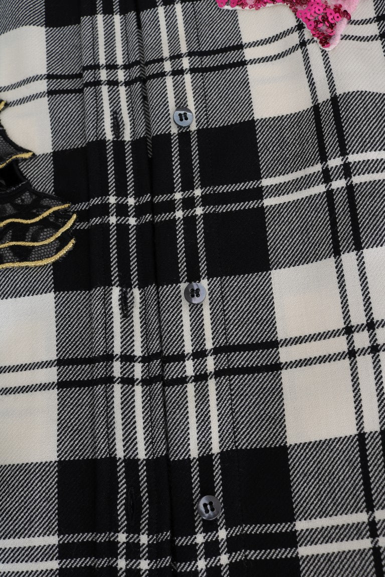Plaid patterned fabric with buttons and a pink flower