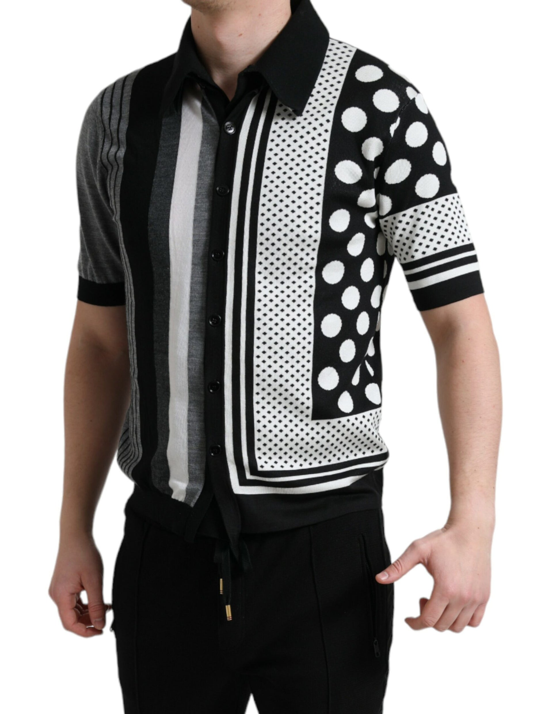 Man wearing a polka dot sweater vest over a striped shirt