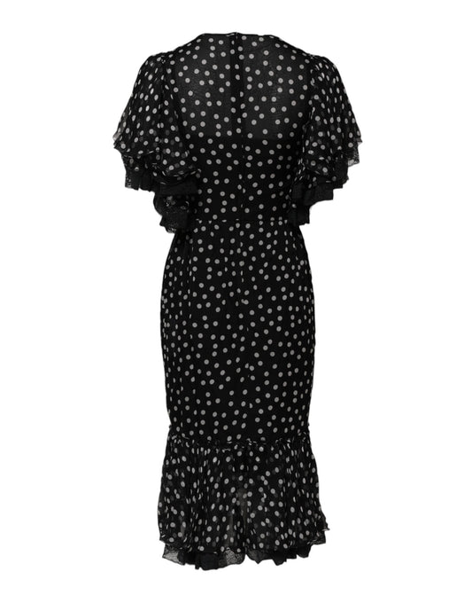A black chiffon dress with white polka dots and ruffled sleeves