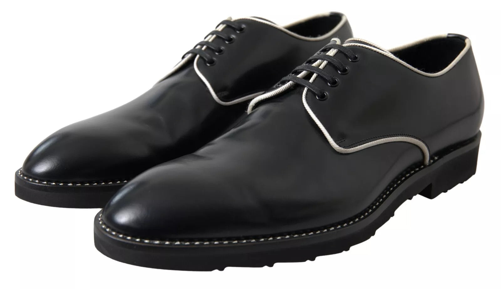 Pair of black leather dress shoes with white laces and soles, featuring a classic design