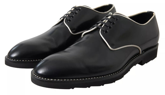 Pair of black leather dress shoes with white laces and soles, featuring a classic design