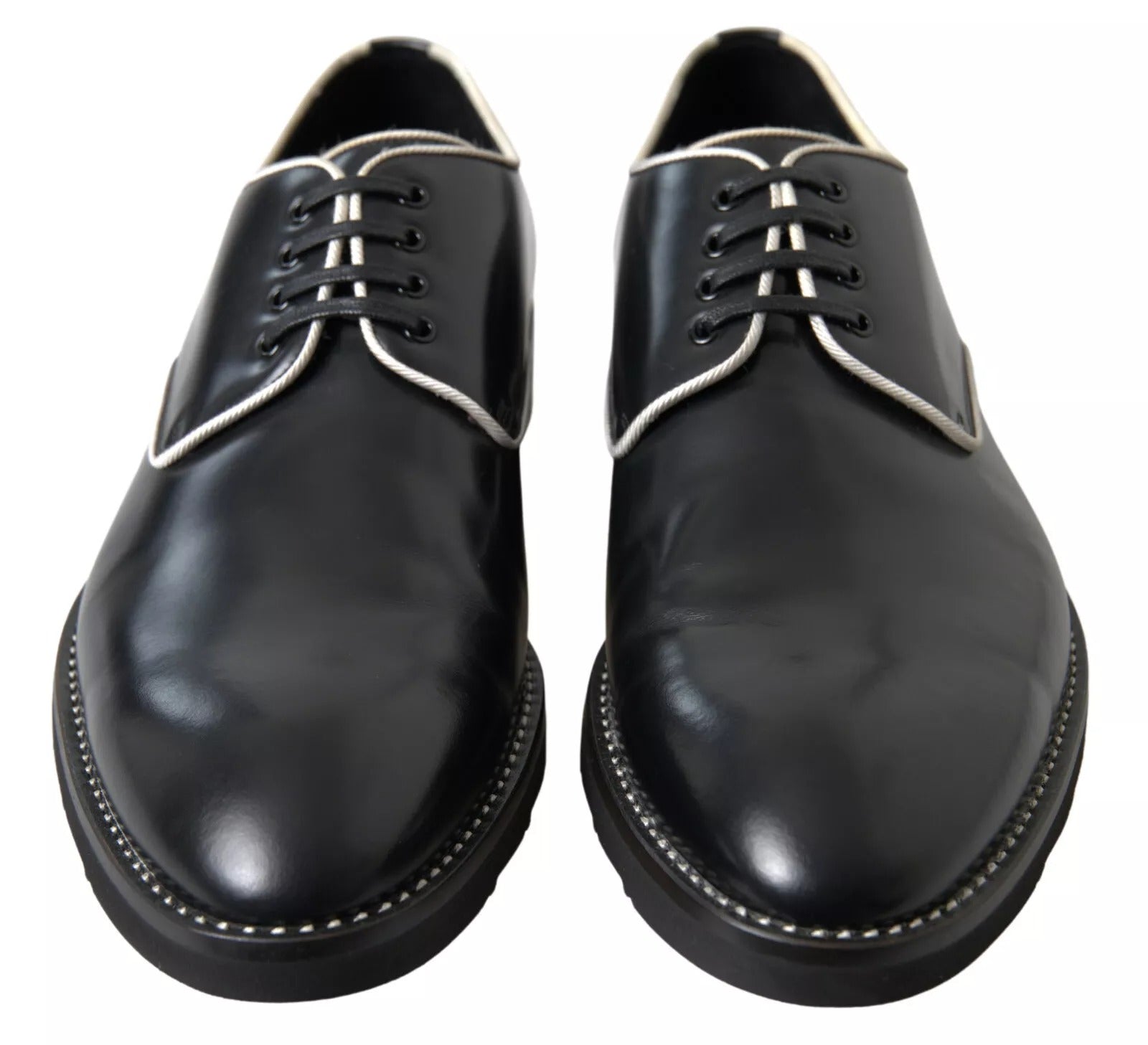 Pair of black leather formal dress shoes with white laces and stitching details, branded by Dolce & Gabbana
