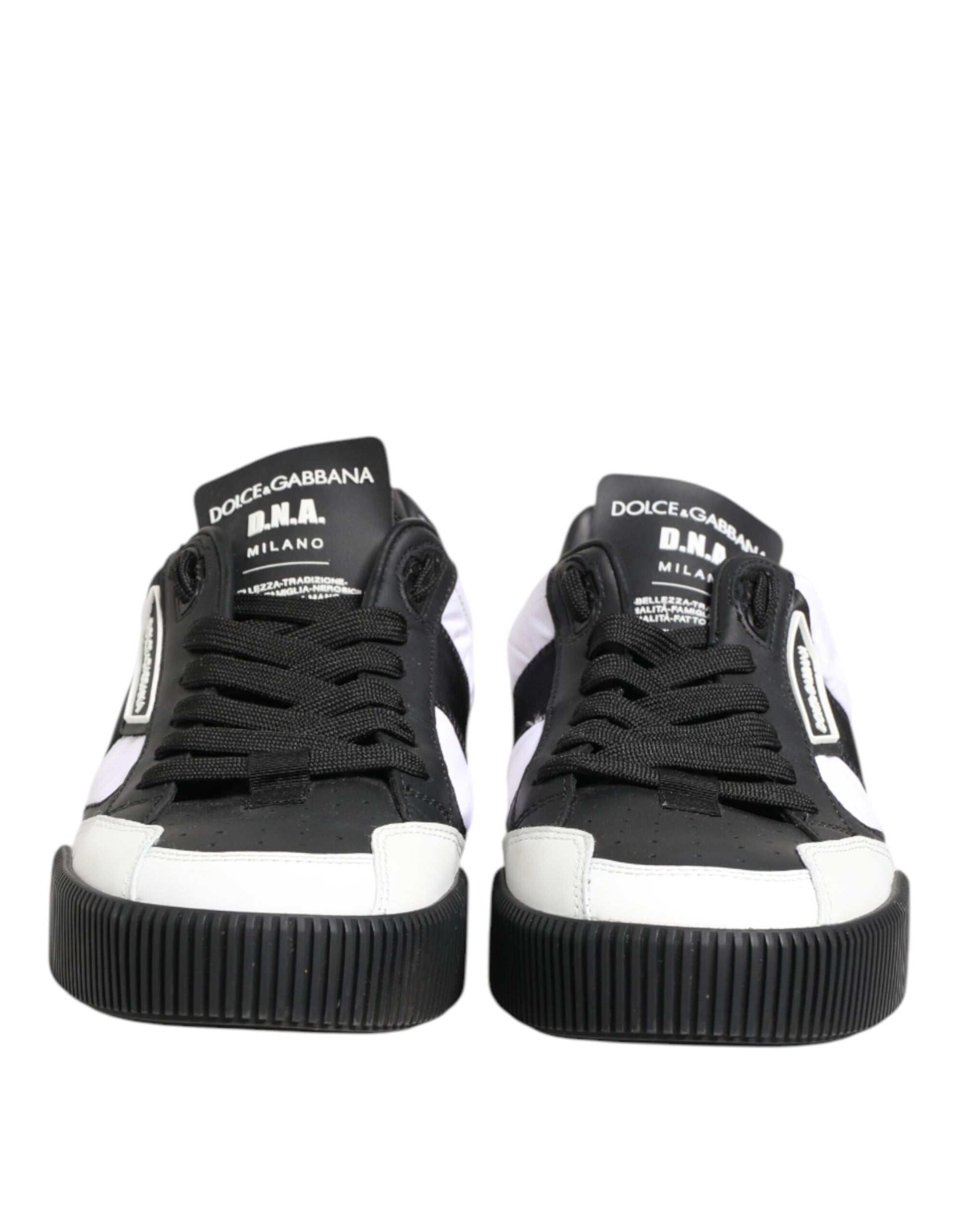 Pair of black and white leather sneakers with brand name on side