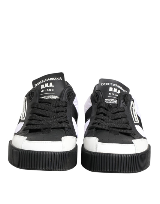 Pair of black and white leather sneakers with brand name on side