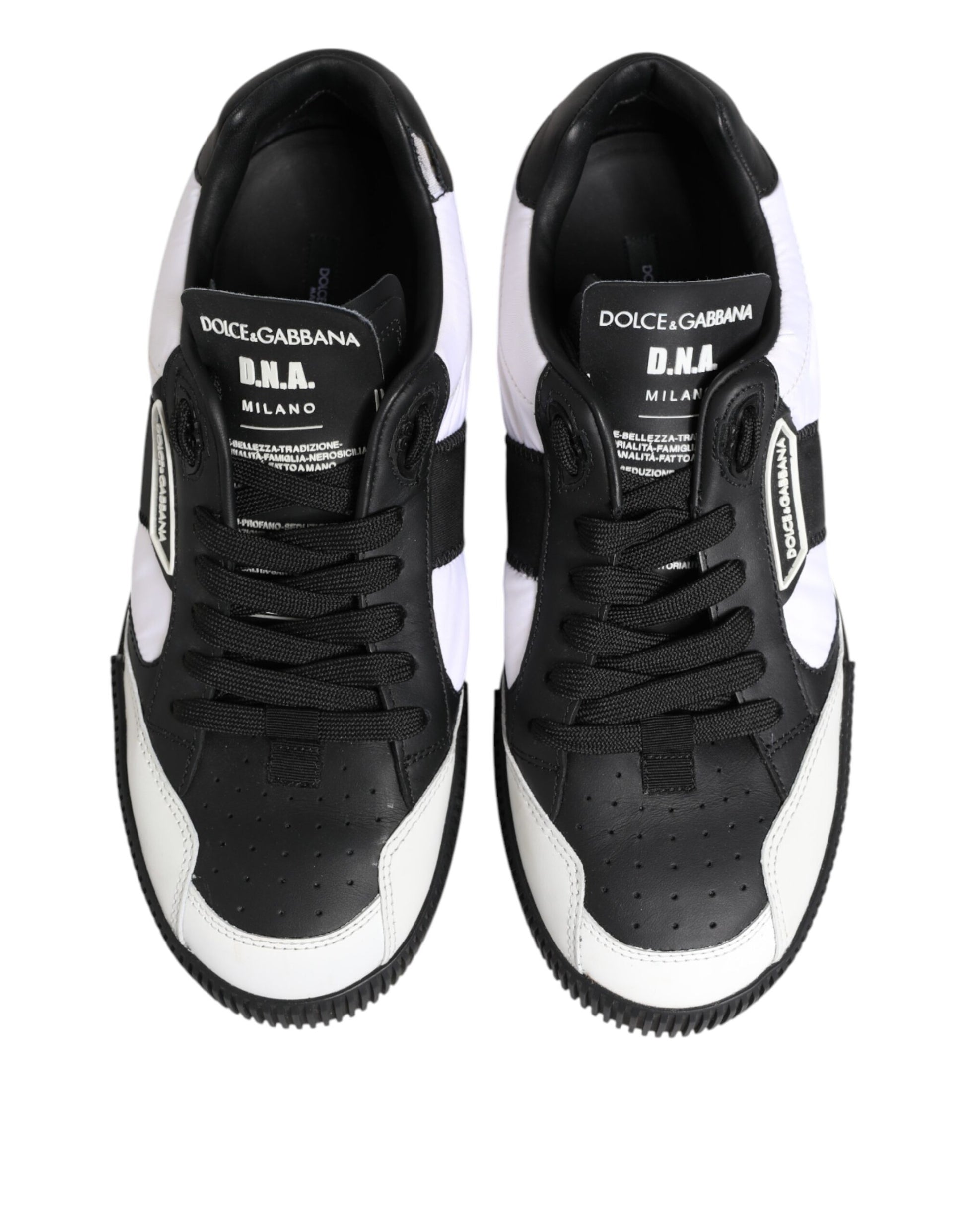 Pair of black and white leather sneakers with brand name on side