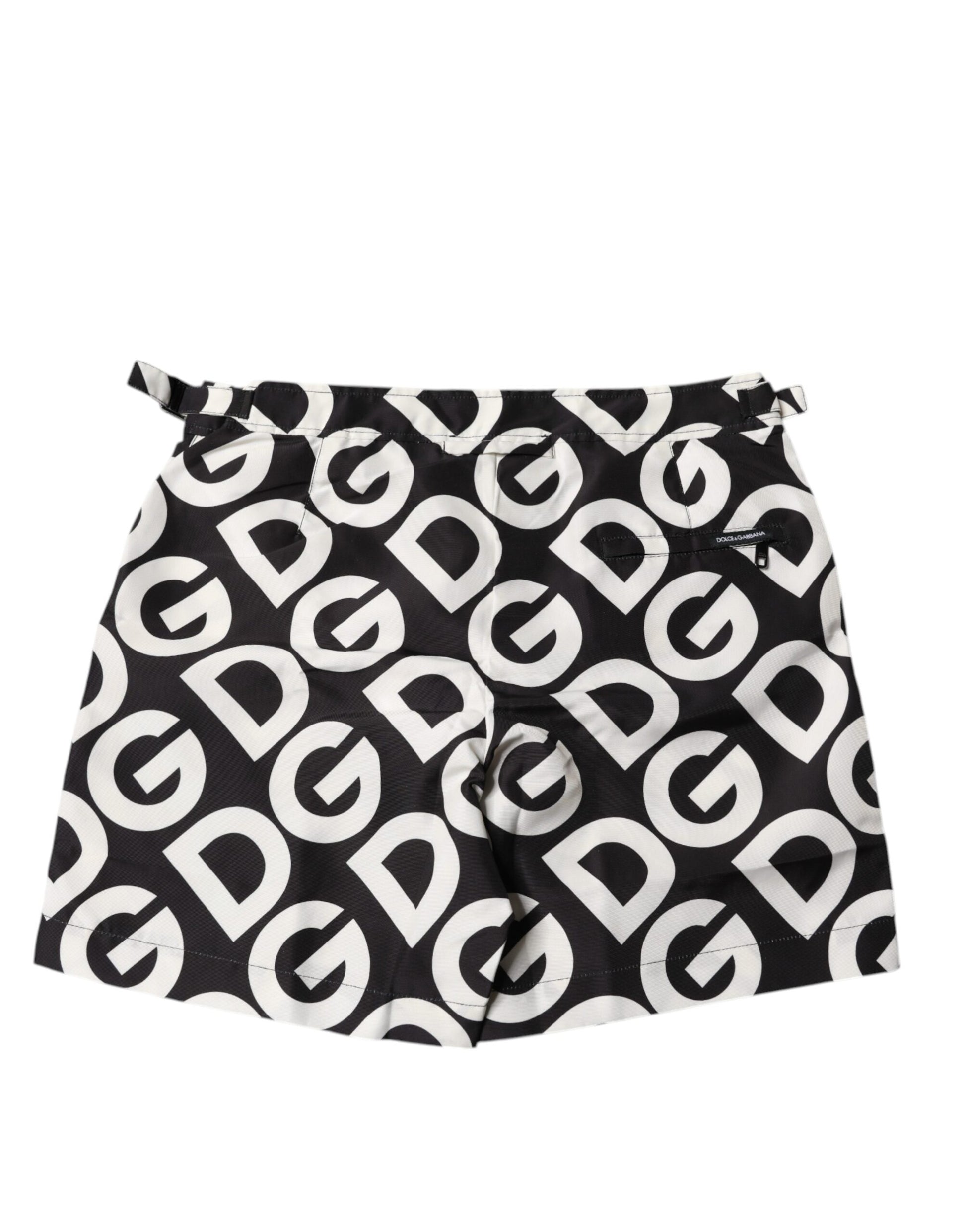 A pair of black and white beach shorts with the Dolce & Gabbana logo