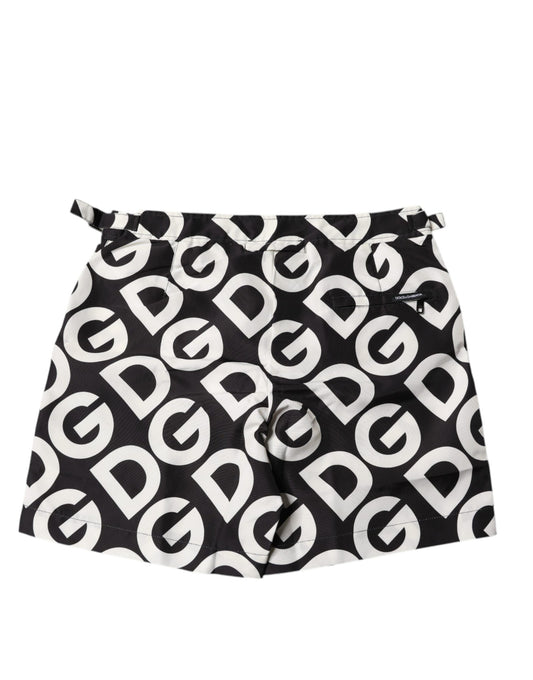 A pair of black and white beach shorts with the Dolce & Gabbana logo