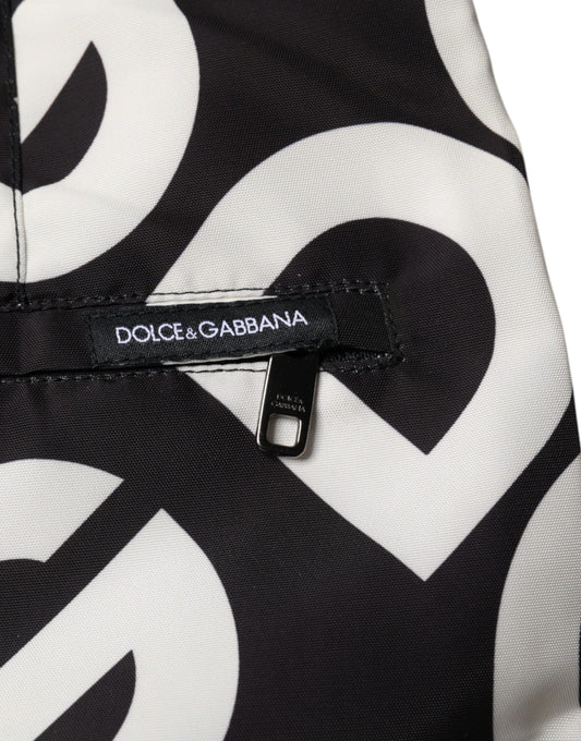 A pair of black and white beach shorts with a logo on the waistband