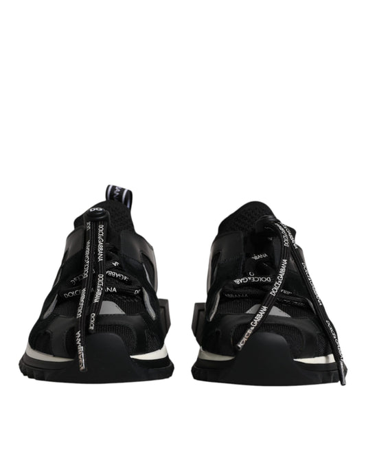 Pair of black sneakers with white laces and a patterned design on the side