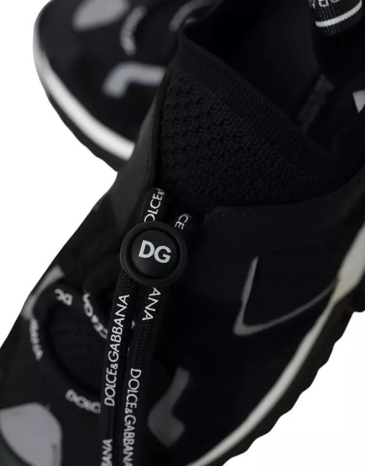 A pair of black and white sneakers with a logo on the side, featuring a lace-up closure
