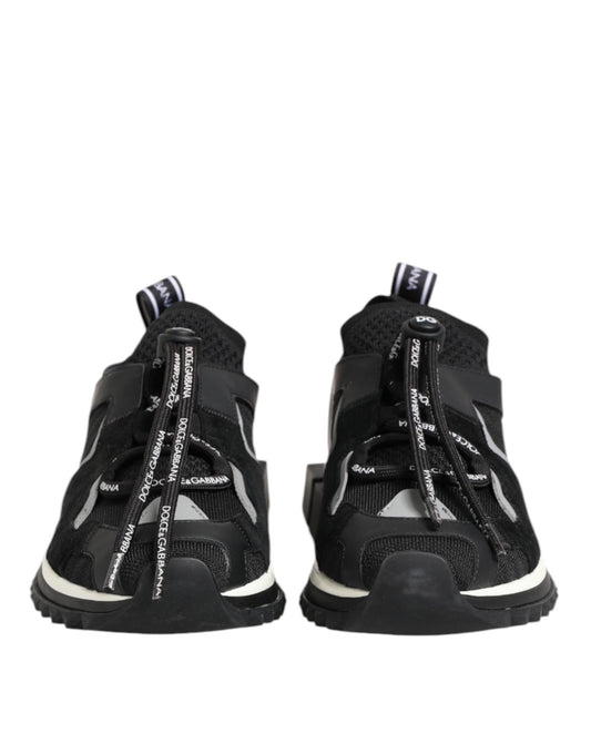 Pair of black baby shoes with white soles