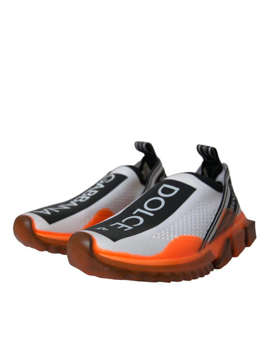 Pair of orange and white running shoes with black laces