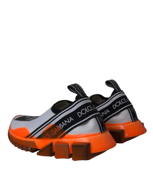 Pair of orange and white sneakers with black straps and a logo on the side