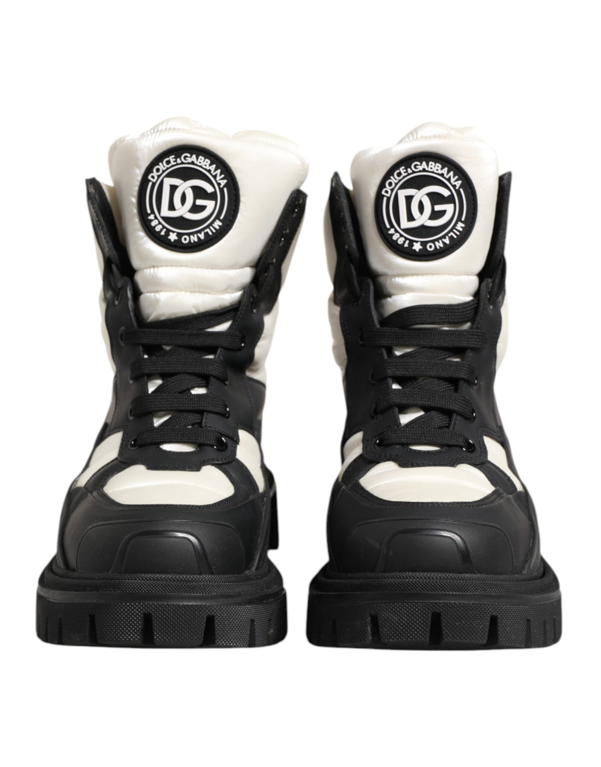 Pair of black and white boots with a logo on the side