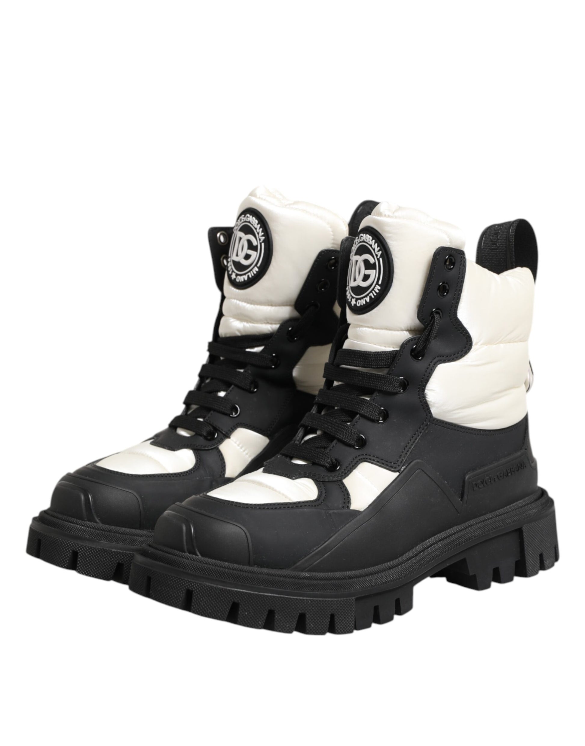 Pair of black and white boots with a logo on the side