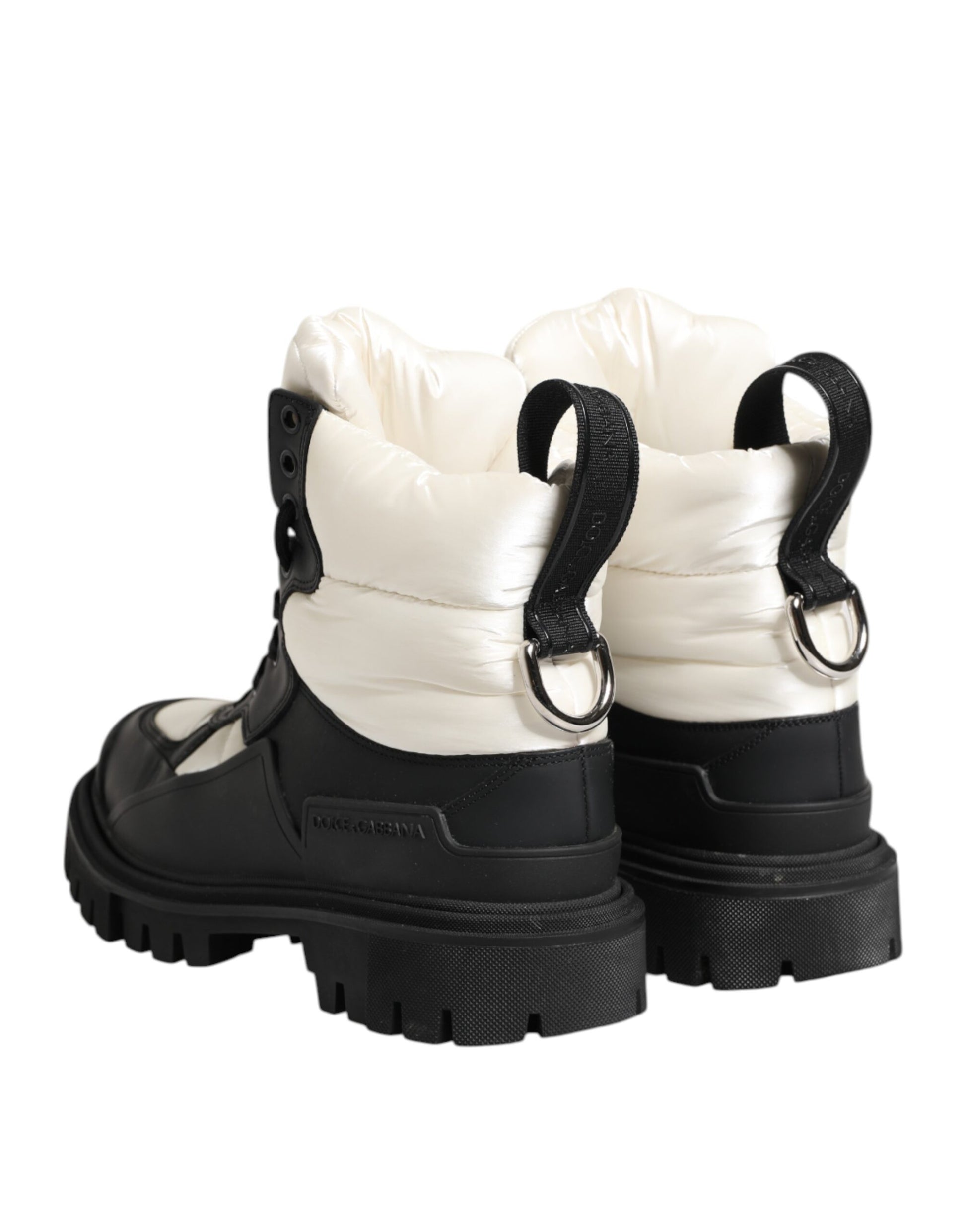 Pair of black boots with white trim and laces