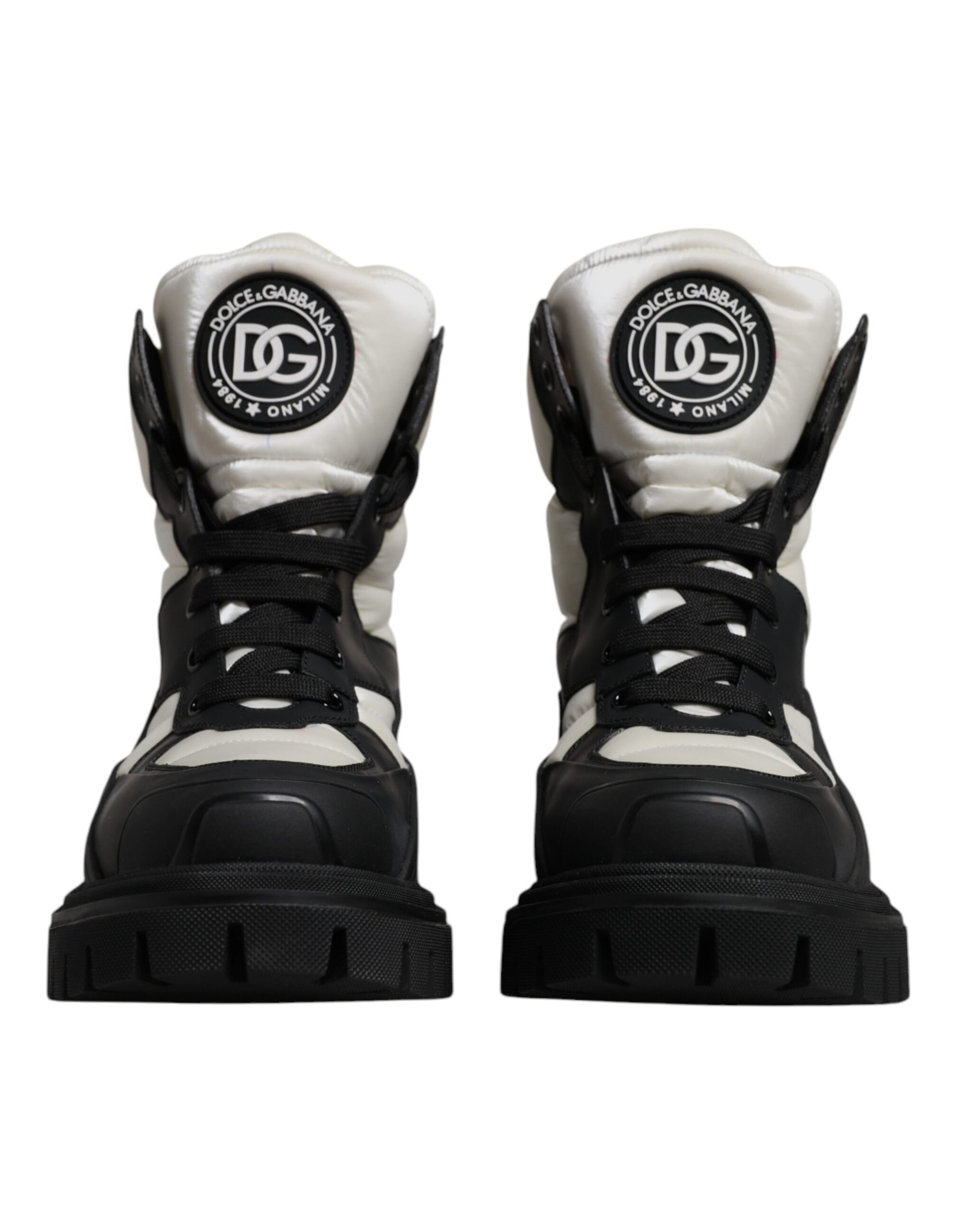 Pair of black and white boots with laces and a logo on the side