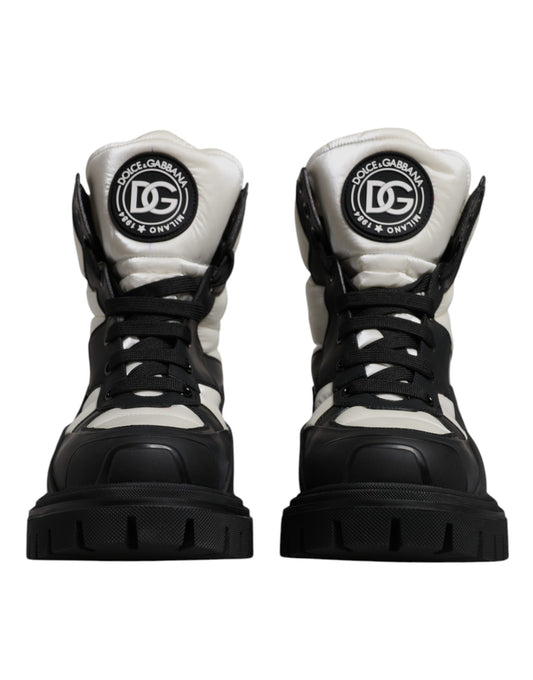 Pair of black and white boots with laces and a logo on the side